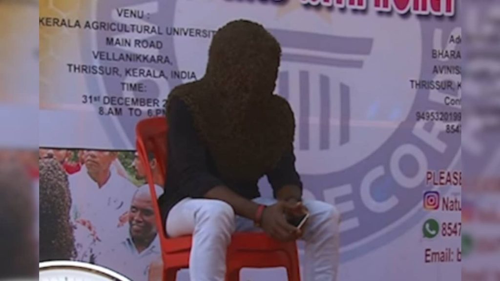 Kerala Man covers his face from honey bee